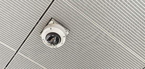 Das Bild zeigt eine Videokamera an der Decke in einer Station