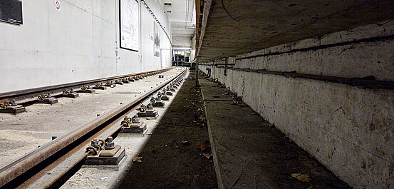 Das Bild zeigt einen Unterrollraum an einem unterirdischen Bahnsteig.